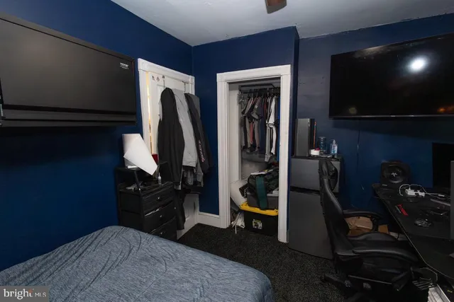 a bedroom with a bed and a flat tv screen