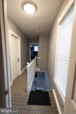 a view of entryway with furniture and wooden floor