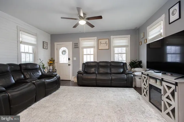 a living room with furniture and a flat screen tv