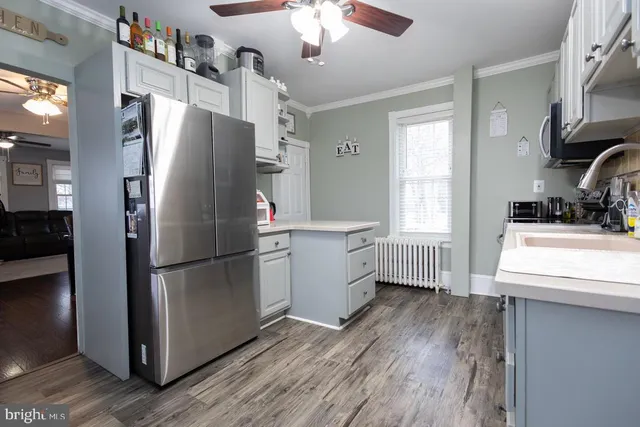 a kitchen with stainless steel appliances a refrigerator sink and cabinets