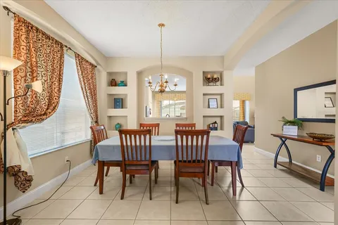 a living room with furniture a fireplace and a kitchen view
