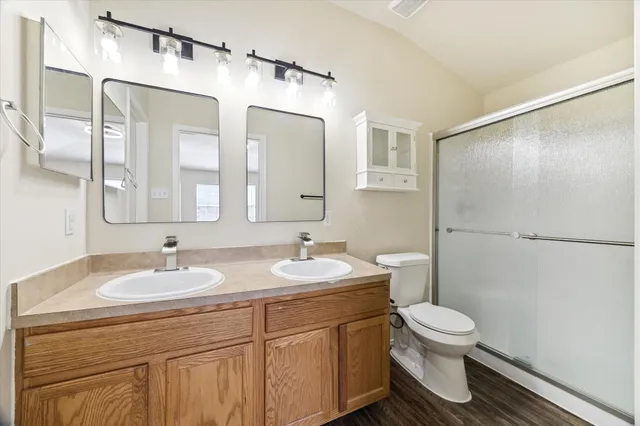 a bathroom with a sink toilet and shower