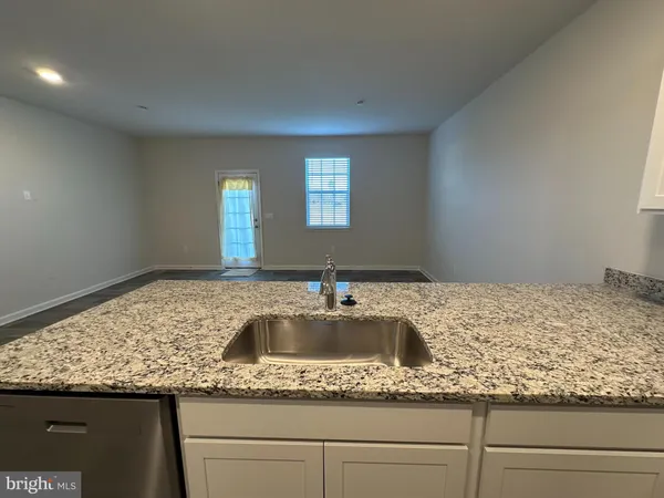 a kitchen with sink and granite