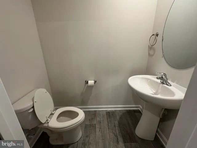 a bathroom with a sink mirror and toilet