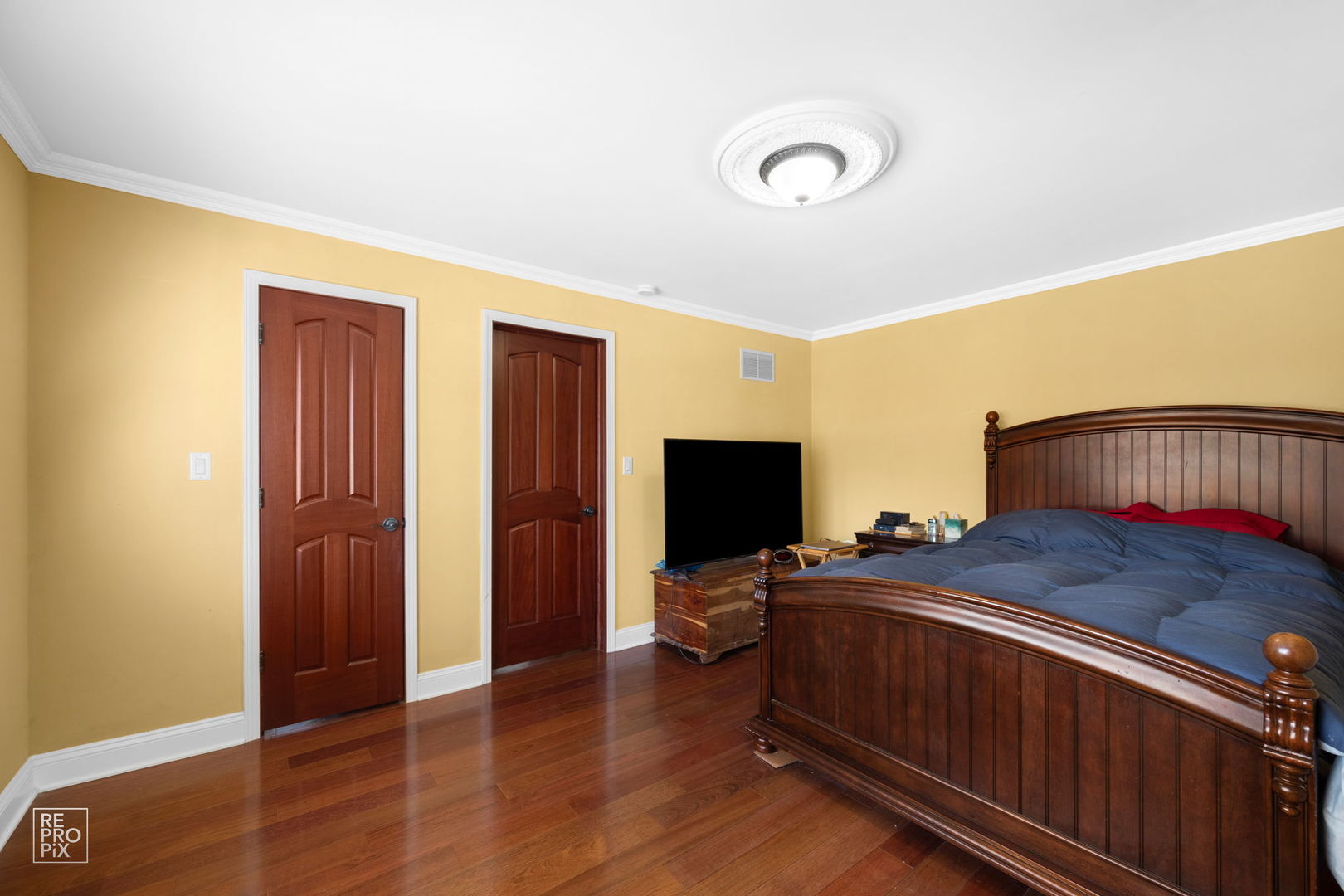 726 South Naperville Road Wheaton, IL 60187 - Photo 13 of 28 a bedroom with a bed and a flat tv screen on dresser