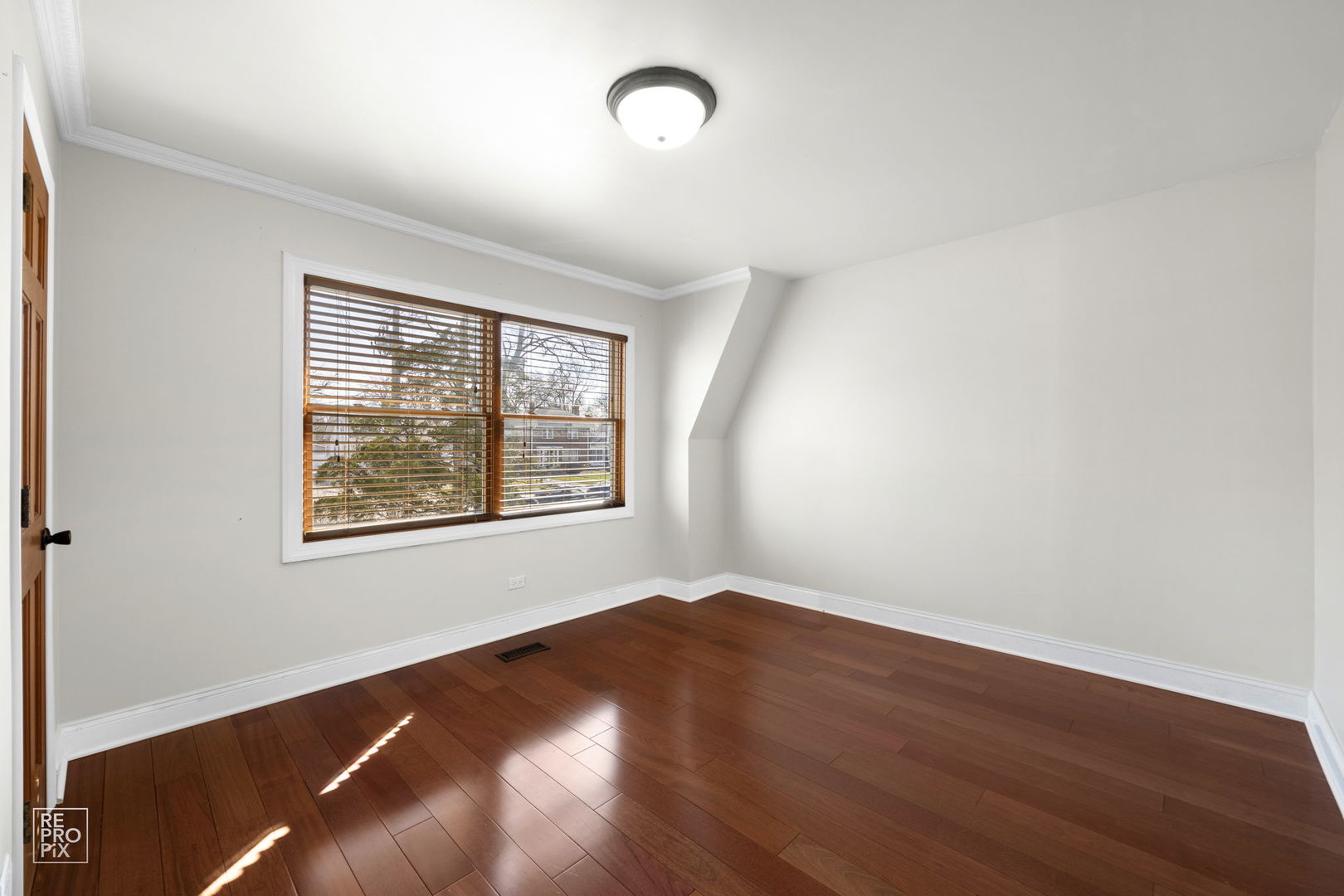 726 South Naperville Road Wheaton, IL 60187 - Photo 14 of 28 an empty room with wooden floor and windows