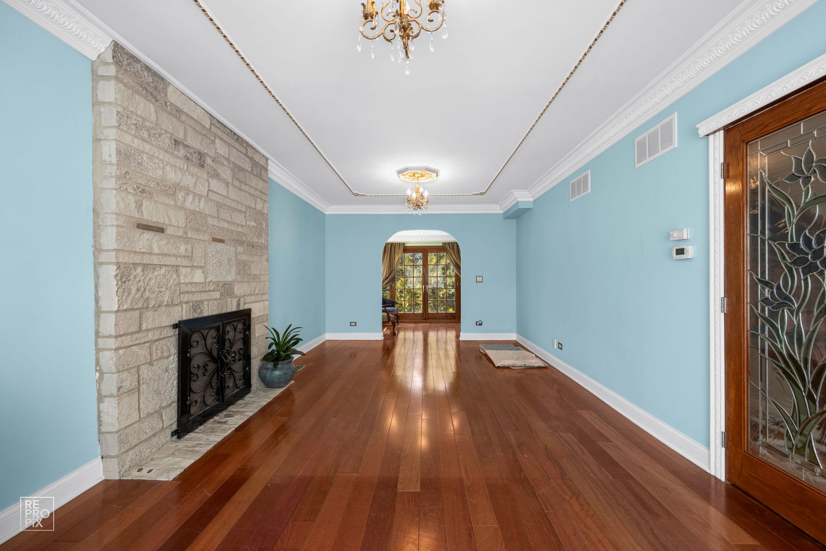 726 South Naperville Road Wheaton, IL 60187 - Photo 8 of 28 a view of empty room with wooden floor and fireplace