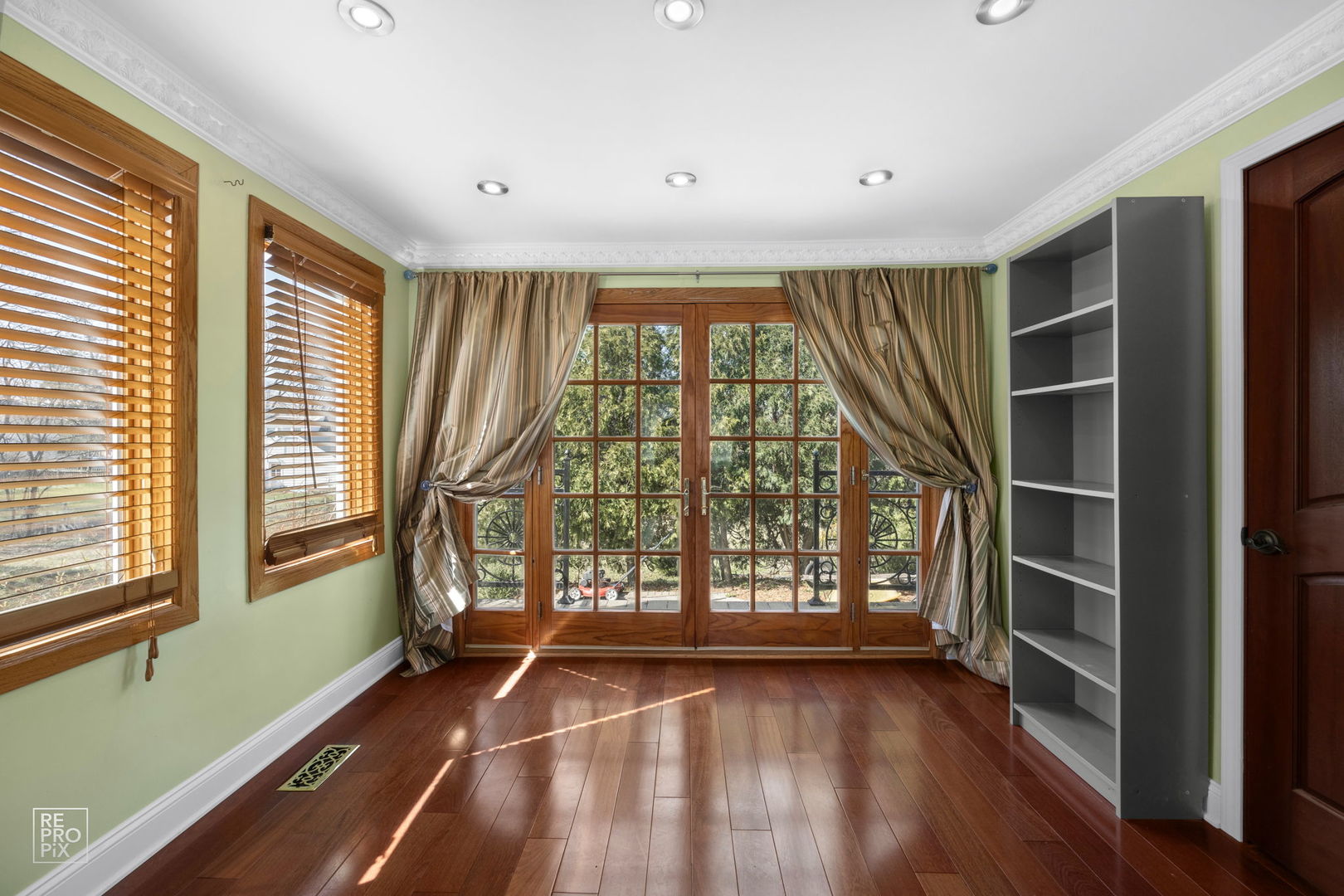 726 South Naperville Road Wheaton, IL 60187 - Photo 9 of 28 a view of an empty room with wooden floor and a window