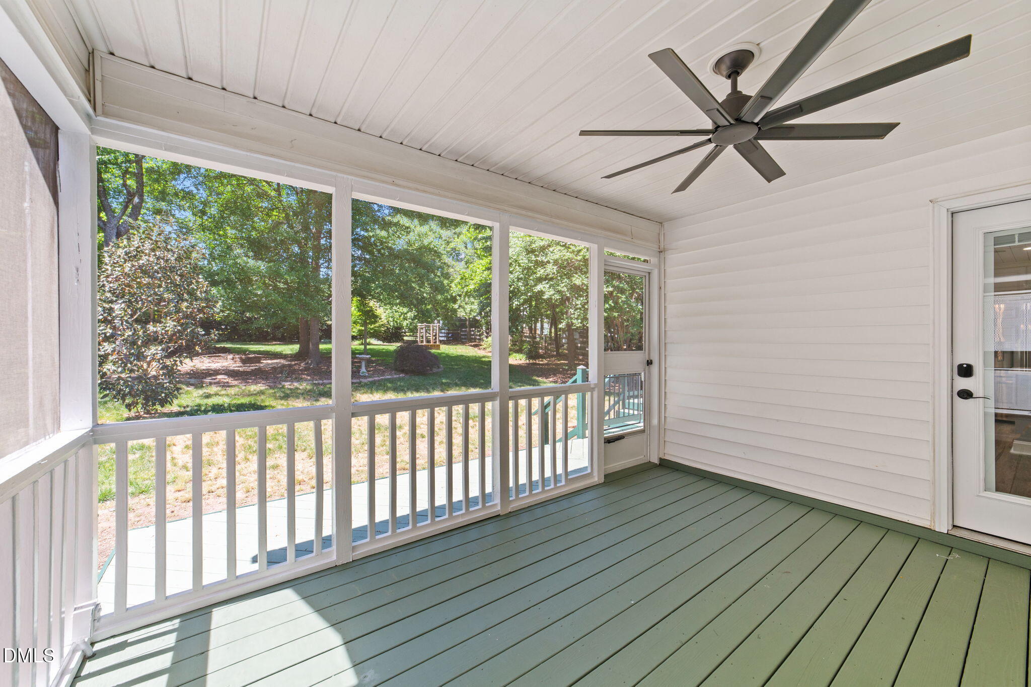 6820 Oviedo Drive Raleigh, NC 27603 - Photo 35 of 50 a view of a porch with wooden floor a ceiling fan and windows