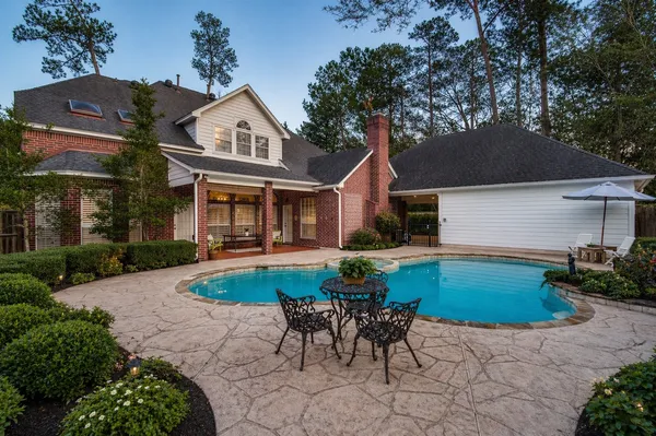 front view of house with a yard and potted plants