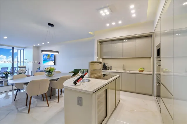 a kitchen with stainless steel appliances kitchen island granite countertop a sink and cabinets