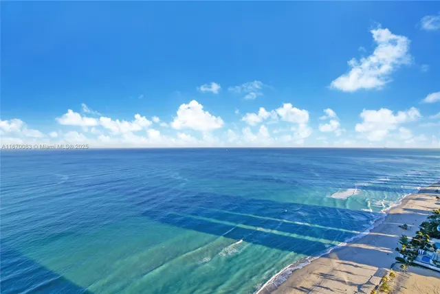 a view of an ocean and a yard