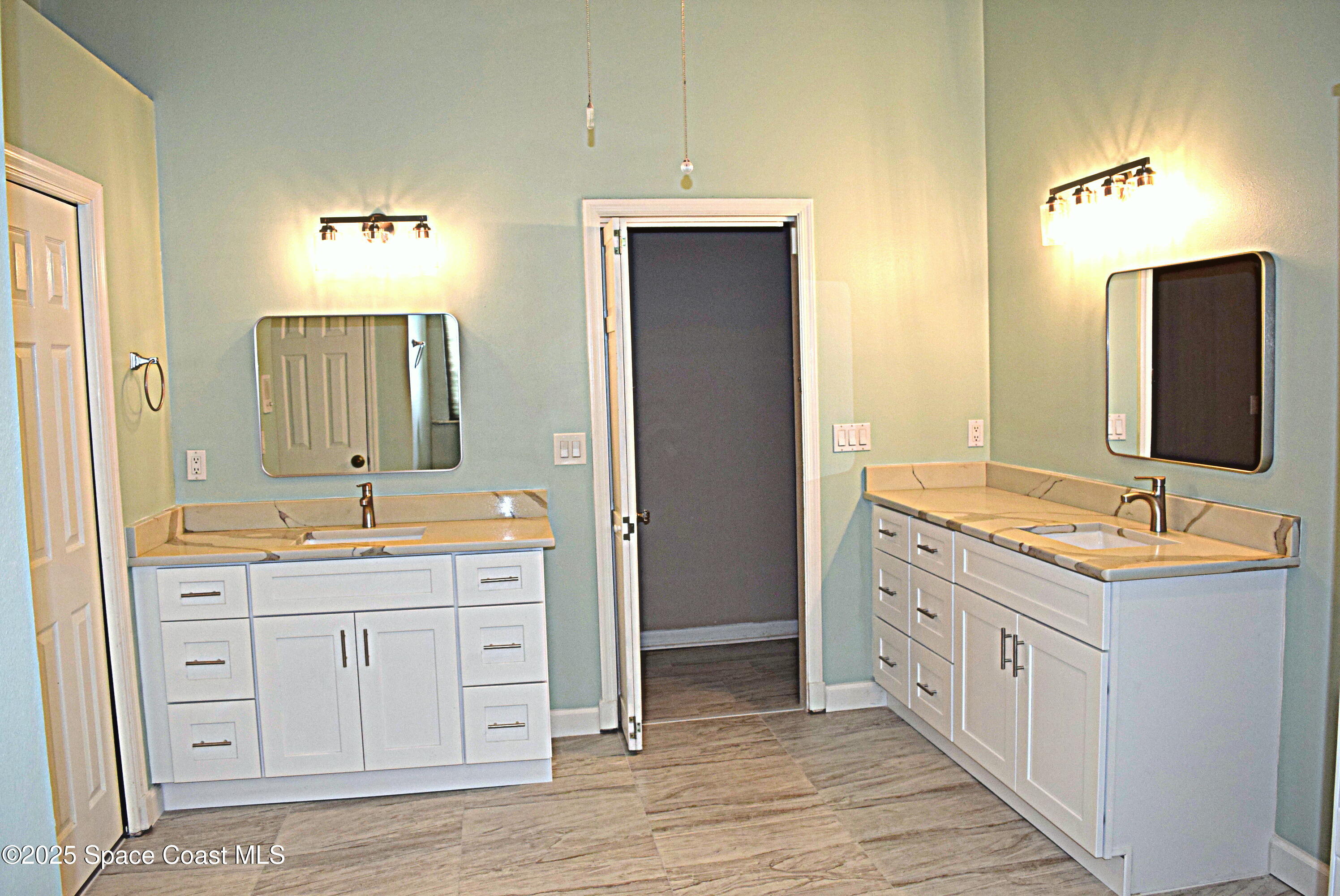 285 Utopia Circle Merritt Island, FL 32952 - Photo 13 of 32 a bathroom with a double vanity sink and a mirror