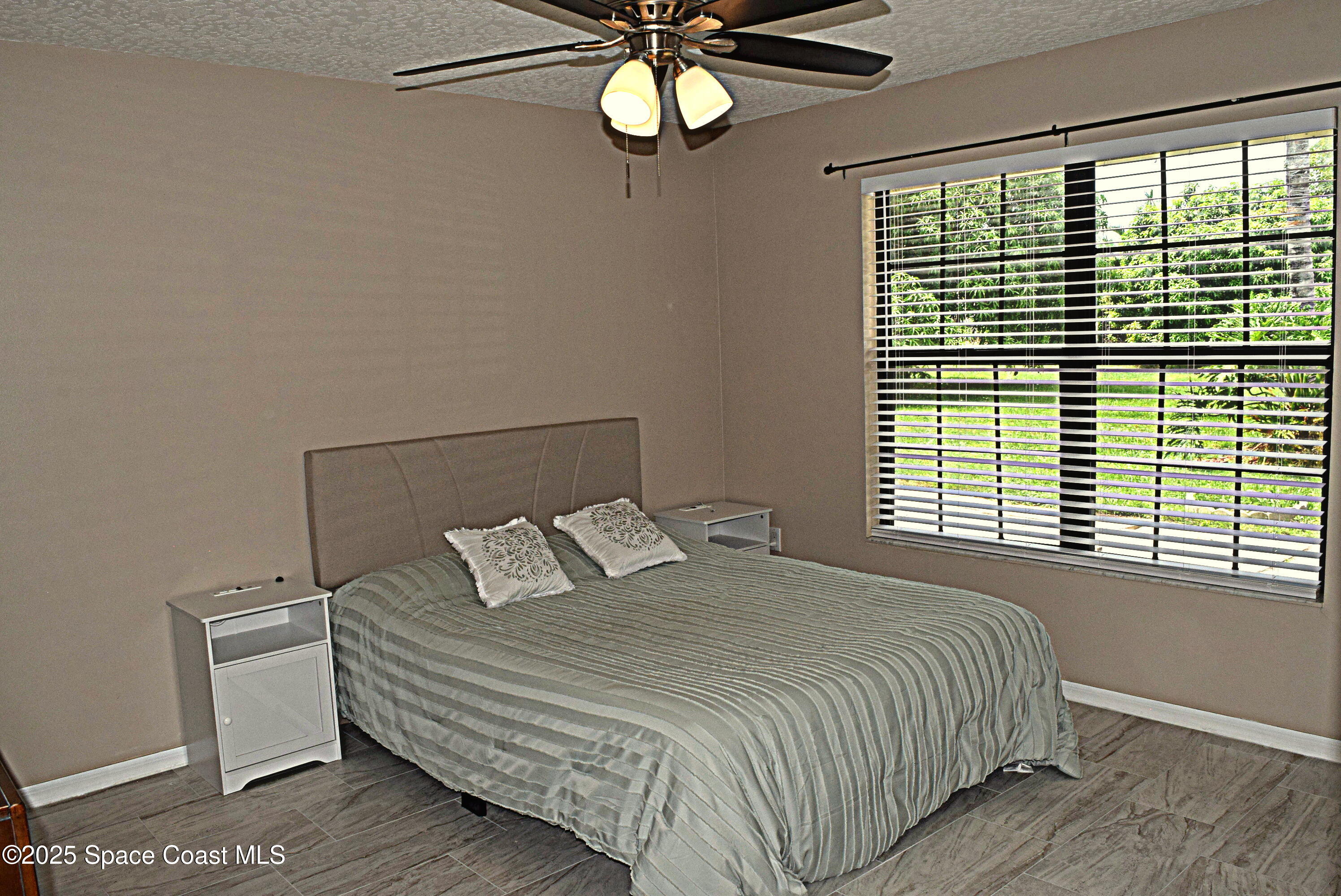 285 Utopia Circle Merritt Island, FL 32952 - Photo 16 of 32 a bedroom with a bed and a window
