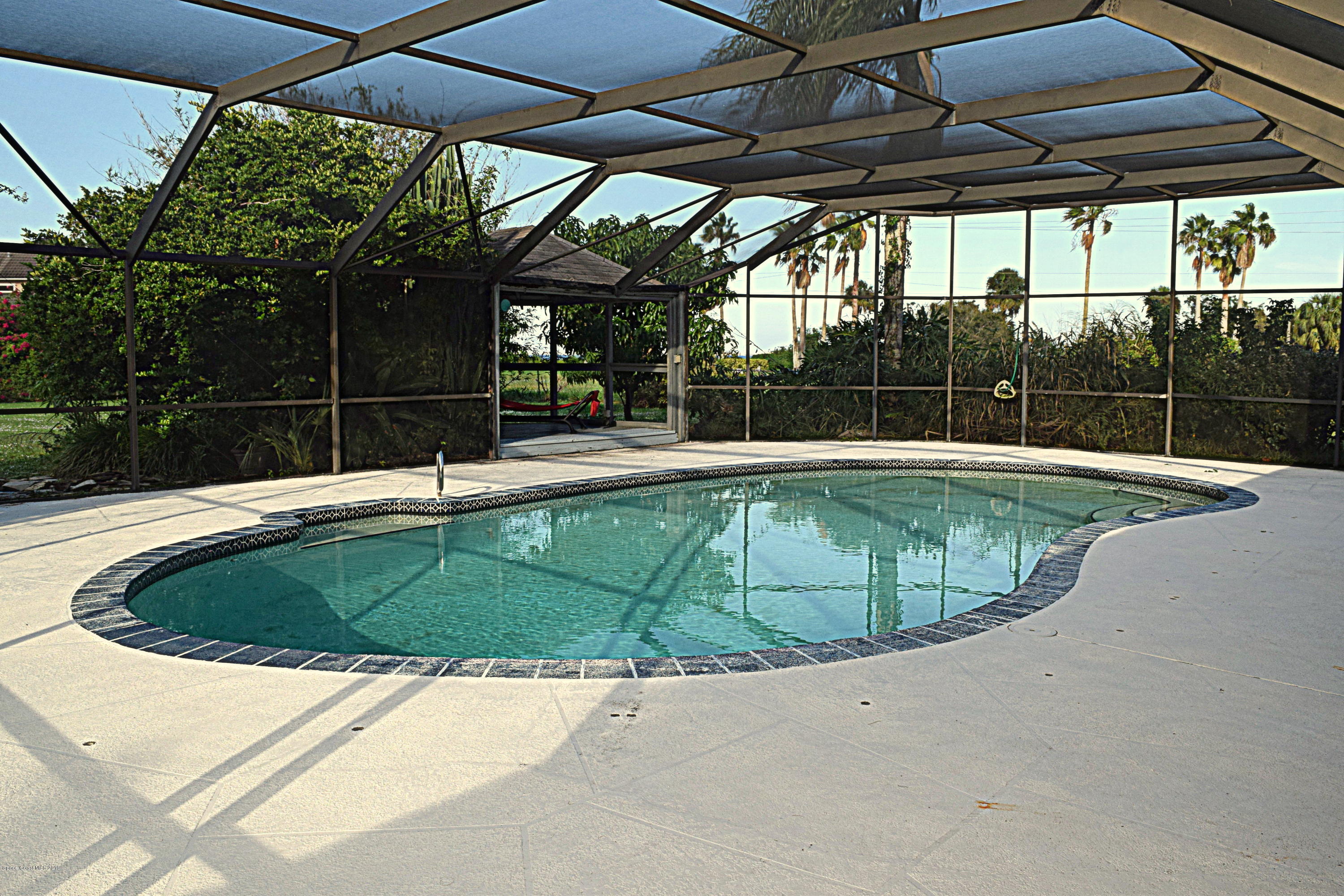 285 Utopia Circle Merritt Island, FL 32952 - Photo 23 of 32 a swimming pool with outdoor seating and yard