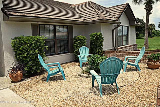 a view of two chairs in a patio