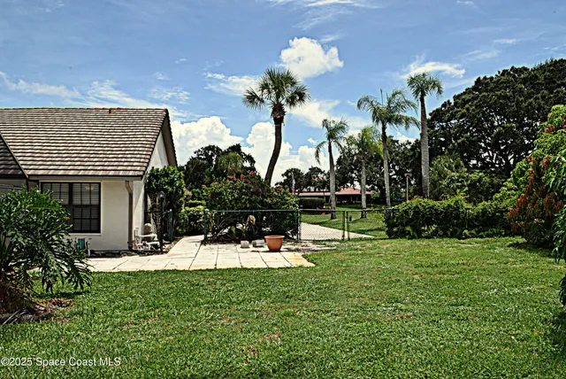 a view of a house with a backyard and sitting area