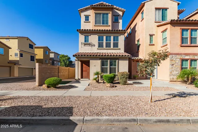 a front view of a house with garden and plants