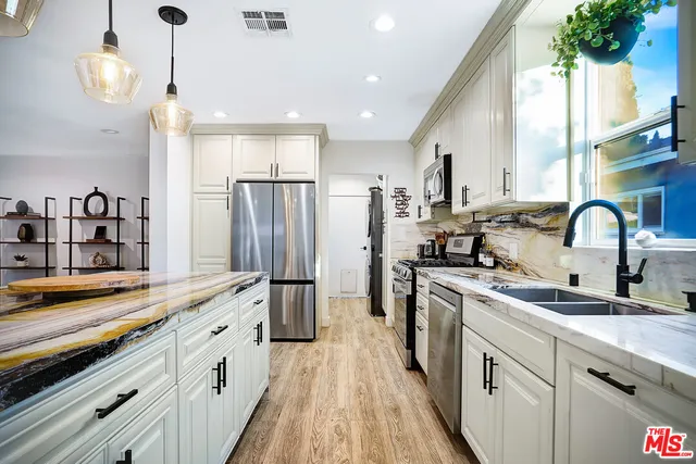 a kitchen with a sink stove and refrigerator
