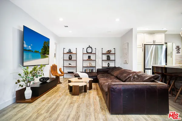 a living room with furniture and kitchen view