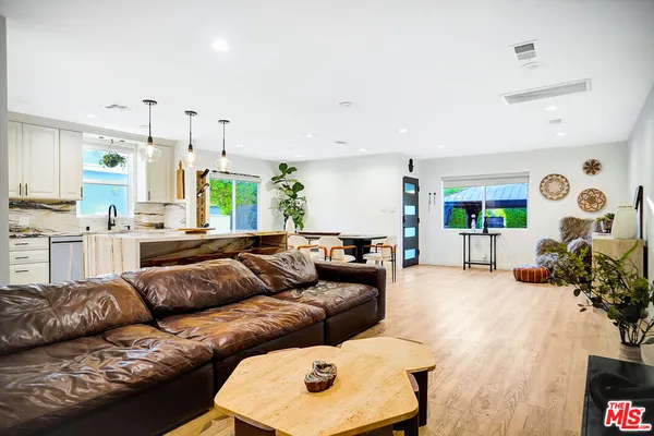 a spacious bedroom with a bed and a chandelier
