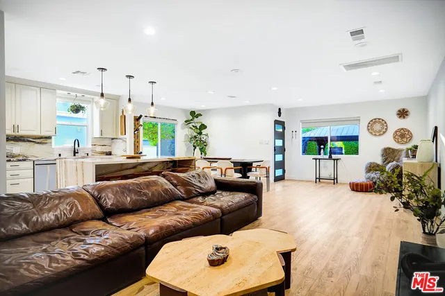 a spacious bedroom with a bed and a chandelier