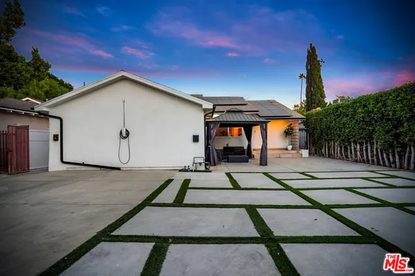 a view of a patio with a table and chairs under an umbrella with wooden floor