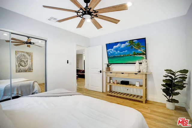 a bed room with a bed and a large window