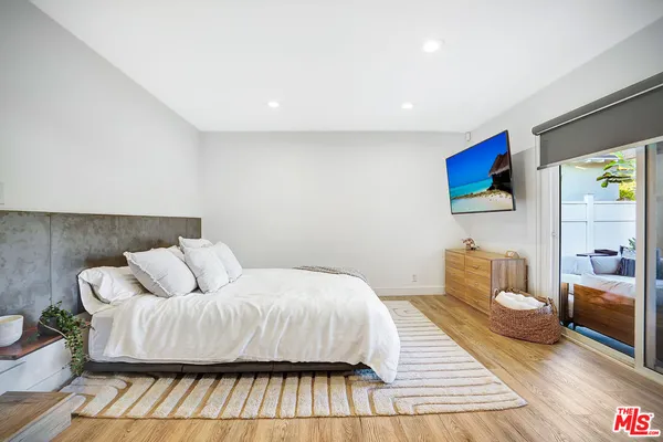 a bedroom with a bed and a couch