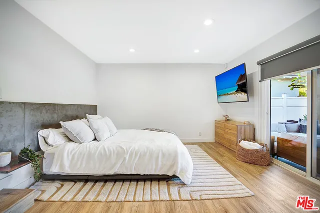 a bedroom with a bed and a couch