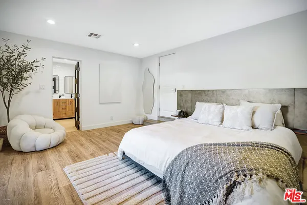 a bathroom with a tub sink shower and mirror