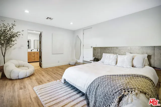a bathroom with a tub sink shower and mirror