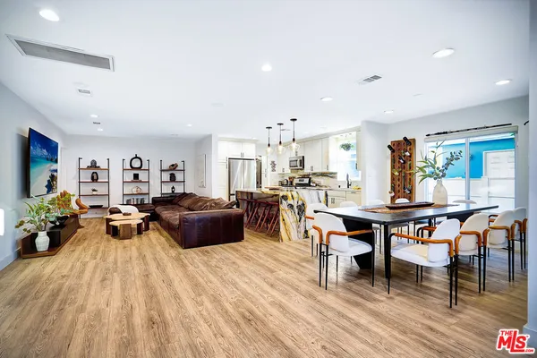 a view of a dining room with furniture and a potted plant