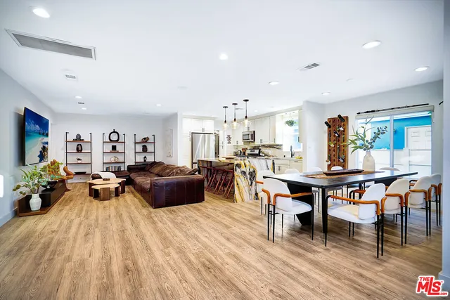 a view of a dining room with furniture and a potted plant