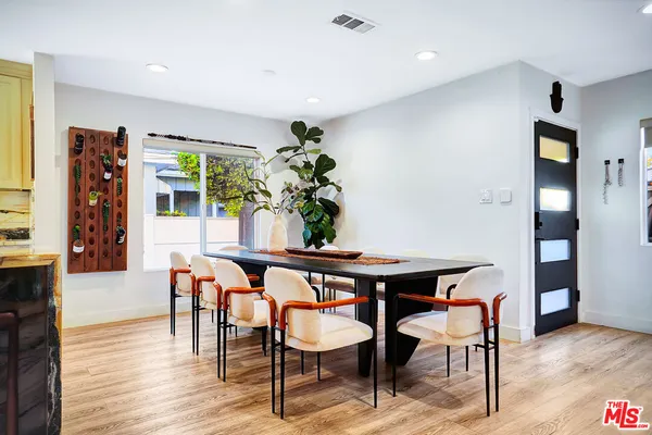 a dining room with furniture and wooden floor