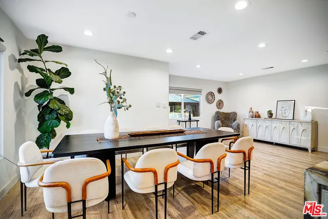 a bedroom with furniture and a wooden floor