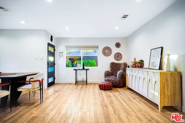 a view of kitchen with stainless steel appliances granite countertop refrigerator stove microwave and cabinets