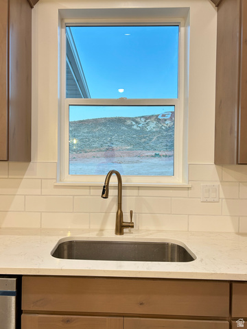 6 South 450th West Gunnison, UT 84634 - Photo 10 of 45 Kitchen sink area featuring a single basin undermount sink, a bronze-finish gooseneck faucet, light-toned countertop, and white subway tile backsplash