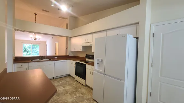 a kitchen with a sink stove and refrigerator
