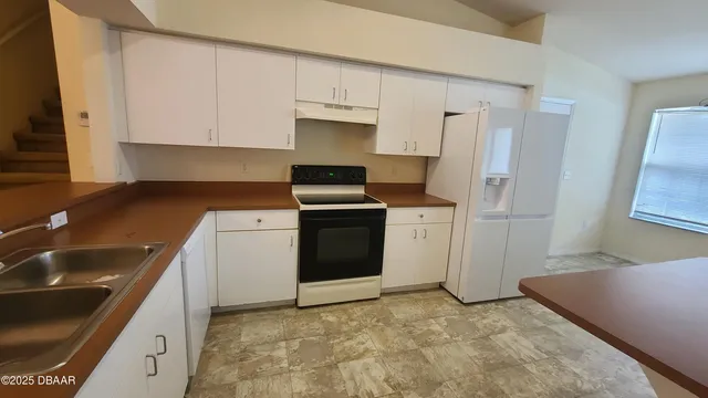 a kitchen with a stove and a refrigerator