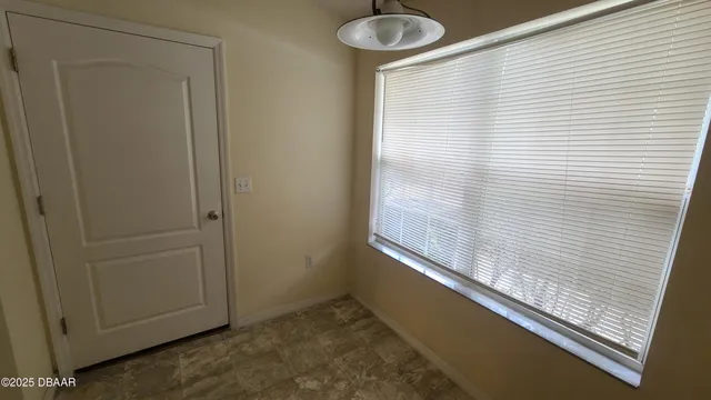 a view of a room with wooden floor and chandelier