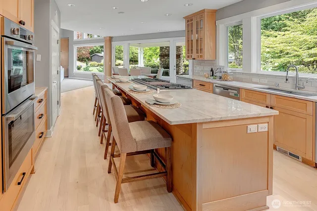 a kitchen with stainless steel appliances granite countertop sink stove and refrigerator
