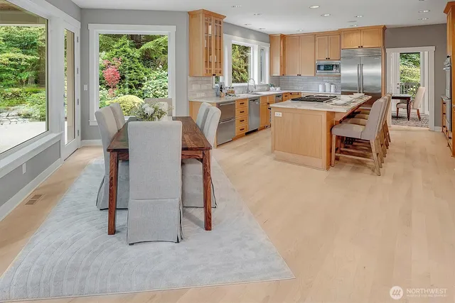 a kitchen with kitchen island granite countertop lots of counter top space and stainless steel appliances