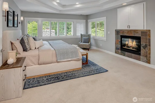 a living room with a couch a window fireplace and windows