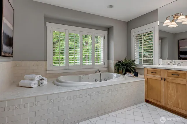 a bathroom with a sink mirror and window
