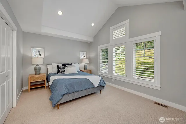 a spacious bedroom with a bed and a large window