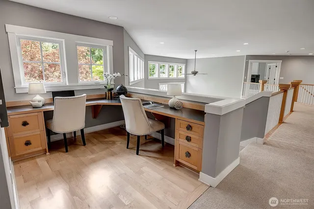 a view of a workspace with furniture and a window