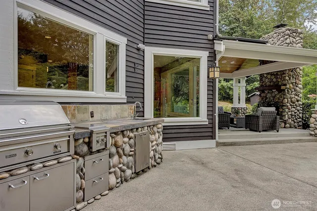 a aerial view of a house with a yard table and chairs