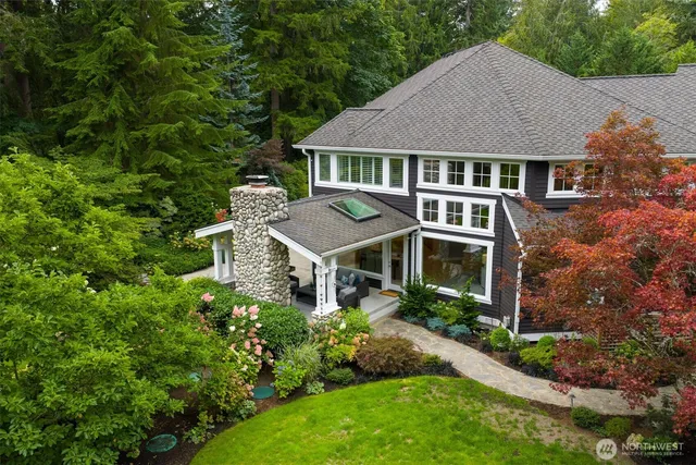 an aerial view of a house with a yard and potted plants
