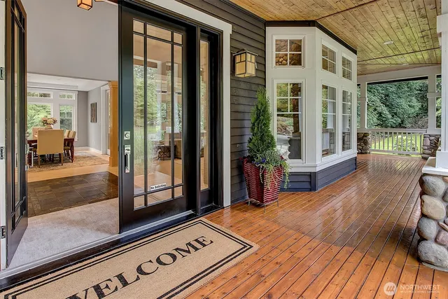a view of a balcony with floor to ceiling windows with wooden floor